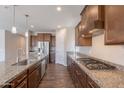 Spacious kitchen featuring a central island, stainless steel appliances, and wood flooring at 98 N Bay Dr, Gilbert, AZ 85233