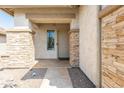 Inviting front entrance with stone accents and a covered porch area at 9816 E Stone Circle E Ln, Gold Canyon, AZ 85118