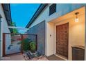 Inviting entrance featuring a modern wood door, unique brickwork, and tranquil water feature at 10007 N 30Th Pl, Phoenix, AZ 85028