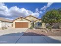 Inviting single-Gathering home featuring a two-car garage and low-maintenance desert landscaping at 10465 E Dutchmans Trl, Gold Canyon, AZ 85118