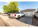 View of the home's front exterior, highlighting the garage and driveway at 11221 W Devonshire Ave, Phoenix, AZ 85037