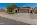 Attractive single-Gathering home featuring a two-car garage and desert-style front yard landscaping at 11341 W Barbara Ave, Peoria, AZ 85345