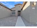 Inviting home entrance featuring stone accents and a well-lit walkway at 1258 W Plane Tree Ave, San Tan Valley, AZ 85140
