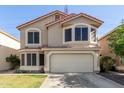 Two-story home with attached garage, tiled roof, arched windows, and established lawn at 1433 E Mineral Rd, Gilbert, AZ 85234