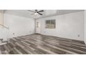 Bright living room with modern gray vinyl plank flooring and a white front door at 1433 E Mineral Rd, Gilbert, AZ 85234