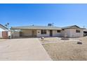 Charming single-story home featuring desert landscaping, a covered parking area, and a welcoming front patio at 1532 W 6Th St, Tempe, AZ 85281