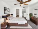 Cozy bedroom featuring a ceiling fan, and an ensuite bathroom and walk in closet at 15650 N 19Th Ave # 1206, Phoenix, AZ 85023