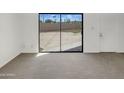 Spacious room features neutral carpet and sliding glass doors leading to the backyard at 15650 N 19Th Ave # 1206, Phoenix, AZ 85023