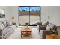 Living room boasts contemporary furniture, a plush rug and sliding glass doors to the backyard at 15650 N 19Th Ave # 1206, Phoenix, AZ 85023