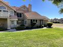 Charming townhome with a cozy porch and well-maintained front yard at 1633 E Lakeside Dr # 154, Gilbert, AZ 85234