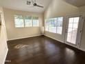 Open living room with hardwood floors, a ceiling fan, and plenty of windows at 1633 E Lakeside Dr # 154, Gilbert, AZ 85234