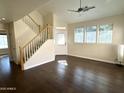Bright living room featuring hardwood floors, staircase, and ample natural light at 1633 E Lakeside Dr # 154, Gilbert, AZ 85234