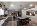 Well-equipped kitchen features stainless steel appliances and a kitchen island with barstool seating at 16461 W Central St, Surprise, AZ 85388