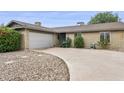 Well-maintained home featuring an attached garage and a spacious driveway with desert landscaping at 1649 W Royal Palm Rd, Phoenix, AZ 85021