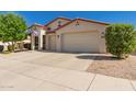 Inviting single-story home with a three-car garage, desert landscaping, and a charming entryway at 17825 W Lincoln St, Goodyear, AZ 85338