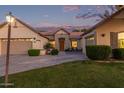 Inviting home showcasing a cozy front patio, a fountain, and a well-manicured lawn during a colorful sunset at 2045 E San Carlos Pl, Chandler, AZ 85249