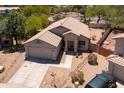 An aerial view of a well-maintained home with a two-car garage and desert landscaping in a residential neighborhood at 20986 N 66Th Ln, Glendale, AZ 85308