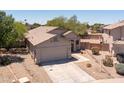 A well-kept home with a desert landscape, a two-car garage, and a tiled roof in a quiet neighborhood at 20986 N 66Th Ln, Glendale, AZ 85308
