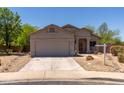 Attractive single-Gathering home with desert landscaping, two-car garage, and a welcoming entrance at 20986 N 66Th Ln, Glendale, AZ 85308