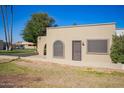 Attractive home with stucco, a decorative archway, desert landscaping and plenty of sunlight at 2211 N Recker Rd, Mesa, AZ 85215