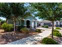 Attractive home with lush trees in the front yard and a three-car garage at 23179 S 225Th Pl, Queen Creek, AZ 85142