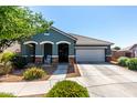 Charming single-story home featuring a well-maintained front yard and a two-car garage at 23179 S 225Th Pl, Queen Creek, AZ 85142