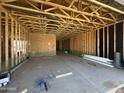 Interior view of a garage with wood framing and concrete floor ready for finishing at 2351 E Homesteader Rd, San Tan Valley, AZ 85140