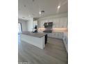 Chef's kitchen boasts a center island, modern stainless hood, white cabinets and hard surface flooring at 24000 S 218Th Pl, Queen Creek, AZ 85142