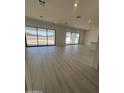 Spacious living room with abundant natural light and modern light wood flooring at 24000 S 218Th Pl, Queen Creek, AZ 85142