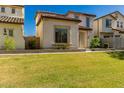 Inviting home boasts lush green grass, a classic tile roof, and desert landscaping at 26521 N Babbling Brook Dr, Phoenix, AZ 85083