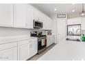 This kitchen boasts white cabinets, stainless steel appliances, and elegant countertops at 32582 N Durango Ln, San Tan Valley, AZ 85143
