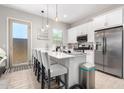 Bright open kitchen with quartz countertops, stainless steel appliances, and an island at 32582 N Durango Ln, San Tan Valley, AZ 85143