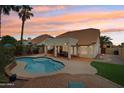 Resort-style backyard with a large pool, covered patio, and desert landscaping at 4043 N Ranier --, Mesa, AZ 85215