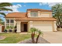 Charming two-story home featuring a well-manicured lawn and desert landscaping at 4043 N Ranier --, Mesa, AZ 85215