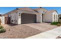 Attractive single-story home featuring brown tile roof, two car garage and low maintenance landscaping at 4051 S Galaxy Ln, Mesa, AZ 85212