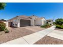 Attractive single-story home featuring brown tile roof, two car garage and low maintenance landscaping at 4051 S Galaxy Ln, Mesa, AZ 85212
