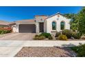 Charming single-story home with a brown tile roof, arched windows and a two car garage at 4051 S Galaxy Ln, Mesa, AZ 85212