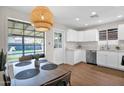 Eat-in kitchen with bright lighting, white cabinets, stainless steel appliances, and a backyard view at 4137 E Sells Dr, Phoenix, AZ 85018