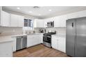 Bright kitchen featuring white cabinets, stainless steel appliances, and a modern design at 4137 E Sells Dr, Phoenix, AZ 85018