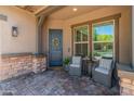 Charming front porch with seating, a decorative wreath on the door, and brick-paver flooring at 4141 E Morrison Ranch Pkwy, Gilbert, AZ 85296