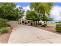 Attractive single-story home with a long driveway and mature shade trees at 41804 W Carlisle Ln, Maricopa, AZ 85138