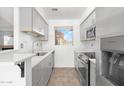 Modern kitchen with gray cabinets, stainless steel appliances, and tile flooring at 420 W Yukon Dr # 4, Phoenix, AZ 85027