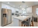 Modern kitchen with white cabinetry, stainless steel appliances, and a stylish center island at 4240 E Bluefield Ave, Phoenix, AZ 85032