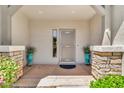 Inviting covered front porch with stone pillars and teal potted plants at 4396 E Austin Ln, San Tan Valley, AZ 85140