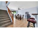 Bright dining room with a ceiling fan and stairway at 4408 W Heyerdahl Dr, New River, AZ 85087