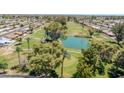 An aerial view of a meticulously maintained golf course with mature trees and a serene water feature at 515 S Parkcrest -- # 531, Mesa, AZ 85206