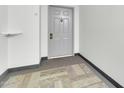 Entryway with neutral decor and carpet that matches the gray painted door at 515 S Parkcrest -- # 531, Mesa, AZ 85206