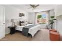 Bright bedroom with neutral tones, ceiling fan, large window, and stylish furnishings at 540 W La Donna Dr, Tempe, AZ 85283