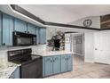 Modern kitchen with ample countertop space and stylish black appliances at 5624 W Villa Theresa Dr, Glendale, AZ 85308