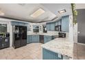Stylish kitchen features updated appliances, marble countertops, and ample cabinet space at 5624 W Villa Theresa Dr, Glendale, AZ 85308